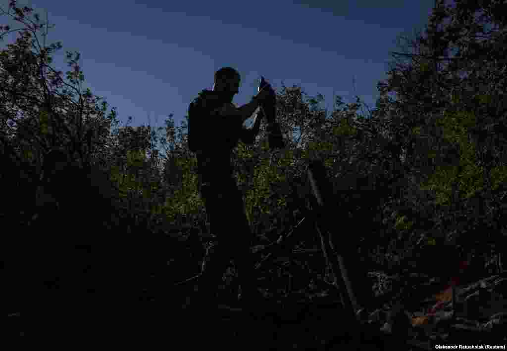 Un soldat ucrainean se pregătește să tragă cu mortiera asupra pozițiilor rusești din apropierea orașului Bahmut, la 7 august. 