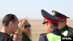 Жол полицейлері Роза Ақылбекова (сол жақтан үшінші) мен Райхан Молдабаеваны (солдан - екінші) ұстап жібермеуге тырысты. Алматы облысы, 20 қазан 2009 жыл.