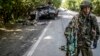 Бойовик угрупування «ДНР» біля знищеного танка українських військ, 22 липня 2014 року