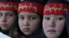 Afghan girls holding placards of mujahedin at the Kabul stadium rally on February 23