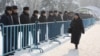 Полиция стоит вдоль металлических ограждений в день акции протеста оппозиции. Алматы, 28 января 2012 года.