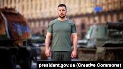Ukrainian President Volodymyr Zelenskiy stands amid a display of damaged Russian armored vehicles in Kyiv on August 24, a date that marks 31 years since Ukraine's independence and six months since Russia began its invasion.