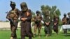Afghan security personnel escort arrested alleged Taliban and Islamic State militants during an operation in Jalalabad on October 1.