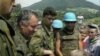 Optuženi za ratne zločine i genocid Ratko Mladić razgovara sa dječakom Izudinom Alićem u Potočarima , jula 1995