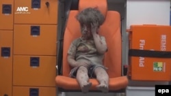 Omar Daqneesh sits bloodied in an ambulance after an air strike in Aleppo.