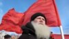 Russia -- A demonstrator with a red Soviet flag stands during a protest rally in Barnaul city in Altai region, 24Mar2010