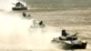 TRussian-built tanks roll under Tajik flags during Peace Mission 2012 joint counterterrorism military exercises of the troops from the six countries in the Shanghai Cooperation Organization in Khujand in June 2012.