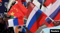 Spectatorii flutură steaguri rusești, chinezești și ale altor țări în timpul unei ceremonii organizate în luna iunie în centrul Moscovei, marcând începutul numărătoarei inverse de 100 de zile până la concursul Intervision din 20 septembrie. 