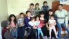 Семья, выселенная по решению суда из попадающего под снос дома, вместе с соседями, которые ее приютили. Астана, ноябрь 2013 года. Иллюстративное фото. 
